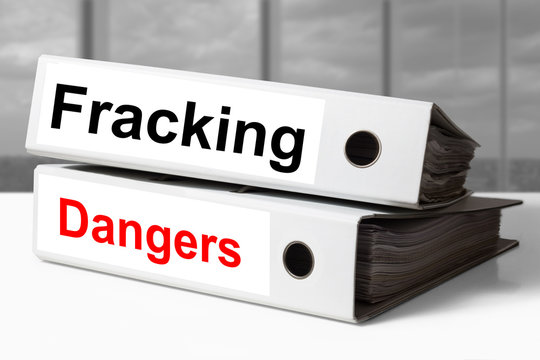 stack of office binders fracking dangers