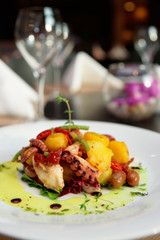 Appetizer with grilled octopus, potatoes and vegetables