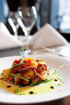 Appetizer with grilled octopus, potatoes and vegetables
