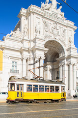 Traditional yellow trams on a street in Lisbon, Portugal