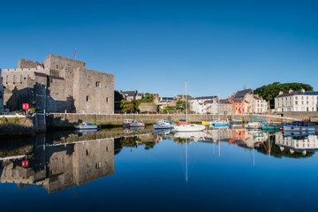 Castle Rushen in Castletown in the Isle of Man, with reflections in the harbour