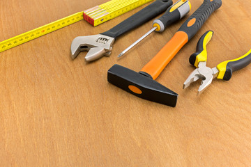 Different hand tools over wooden surface