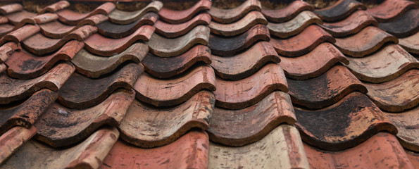 The old roof covered with orange tiles