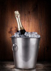 Champagne bottle in a bucket with ice © Gresei