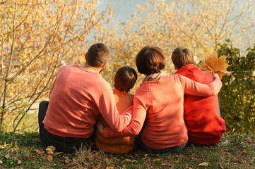 Family relaxing in autumn park