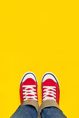 Feet From Above, Teenager in Sneakers Standing on Yellow Backgro