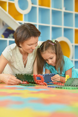 Fototapeta premium girl playing with her mother 