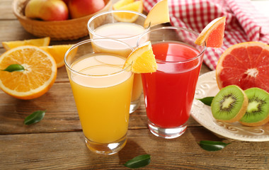 Fresh juices with fruits on wooden table