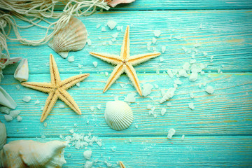 Sea stars and shells on wooden background