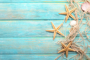 Fototapeta na wymiar Sea stars and shells on wooden background