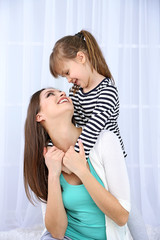 Fototapeta premium Two girls smiling on light background