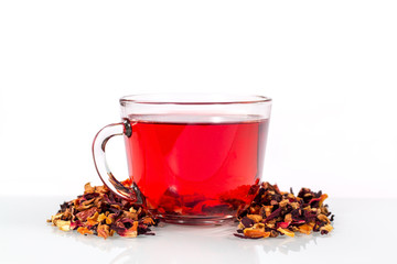 isolated transparent mug of hibiscus tea with tea leaves