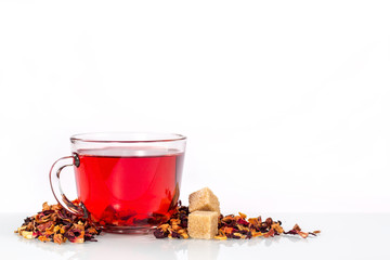isolated transparent mug of karkade tea with tea leaves