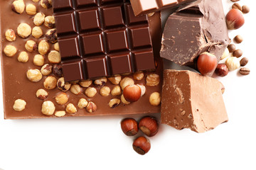 Chocolate bars with hazelnuts and coffee beans close up
