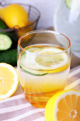 Fresh water with lemon and cucumber in glassware