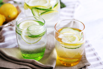Fresh water with lemon and cucumber in glassware