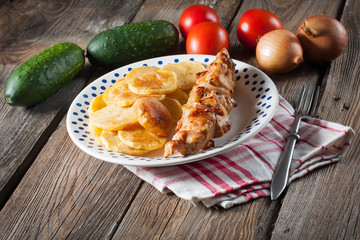 Shashlik with fried potatoes.