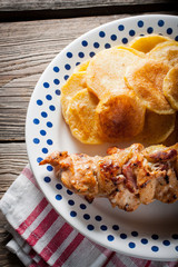 Shashlik with fried potatoes.