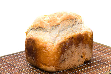 Homemade bread on a bamboo tray on a table on a white background