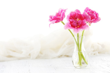 Composition with pink tulips on wooden table, closeup