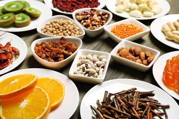 Different products on saucers on wooden table, closeup