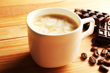 Cup of coffee latte art with grains and chocolate