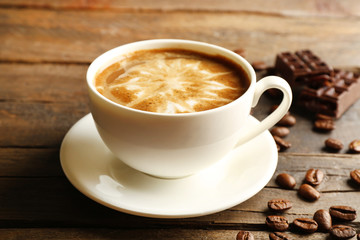 Cup of coffee latte art with grains and chocolate