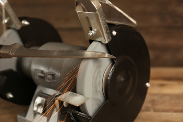 Knife sharpener on wooden table, closeup