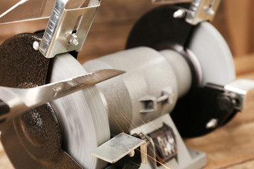 Knife sharpener on wooden table, closeup