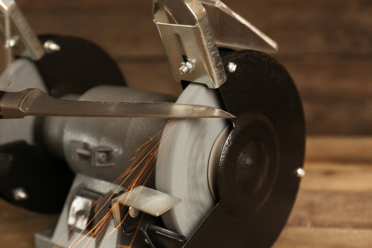 Knife sharpener on wooden table, closeup