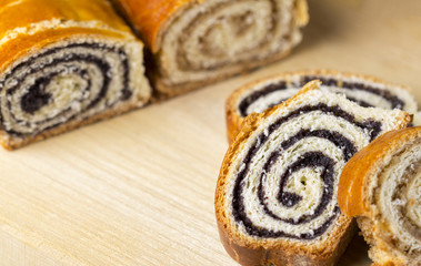Poppy seed and walnut cakes on wooden background