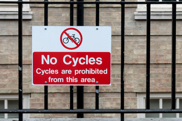 Traffic Sign: No Cycles on Metal Fence -- Cycles are prohibited