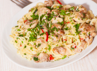 pieces of meat in sauce with spaghetti