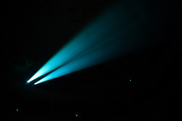 Two beams in dark concert hall.