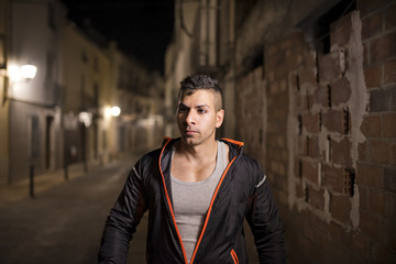 Fototapeta premium Young man in sportswear walking in street