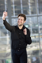 Handsome young man taking selfie while walking