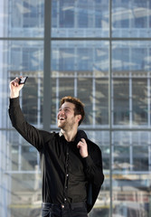 Happy young man taking selfie in the city