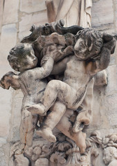 Two cherubs sculpture on the Duomo Cathedral, Milan, Italy