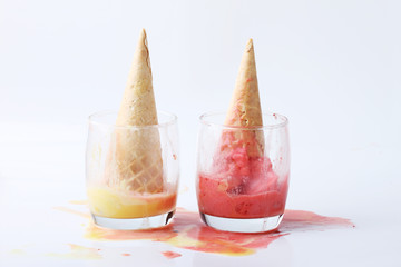 yellow passion fruit and red strawberry ice cream cones dropped