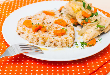 fried chicken with rice in white plate on wooden table