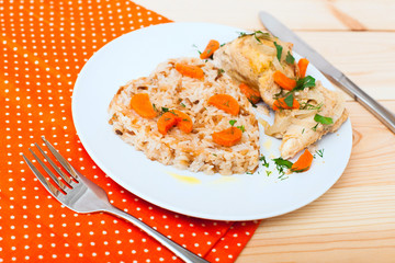 fried chicken with rice in white plate on wooden table