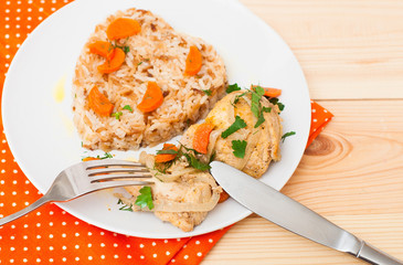 fried chicken with rice in white plate on wooden table