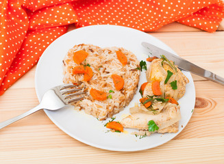 fried chicken with rice in white plate on wooden table