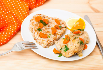 fried chicken with rice in white plate on wooden table
