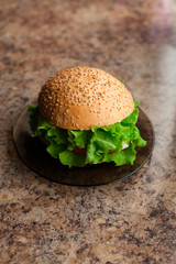 Homemade hamburger with fresh green lettuce, tomato and red onio