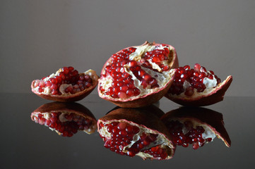 Pieces of pomegranate reflected in the glass surface