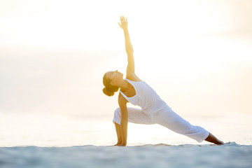 Caucasian woman practicing yoga at seashore © Maygutyak