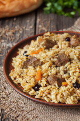 Traditional arabic spicy rice food with meat, onion carrot and