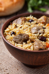 Tasty traditional pilaf meal with rice, fried meat, onion and