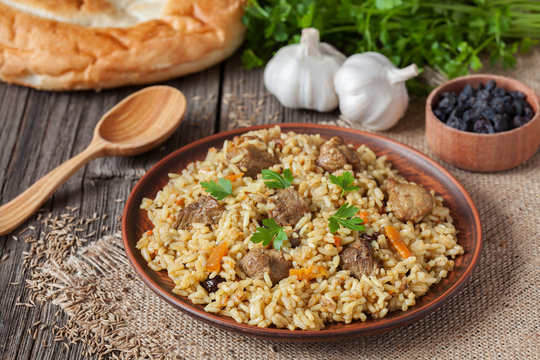 Traditional uzbek meal pilaf. Rice with meat, carrot and onion